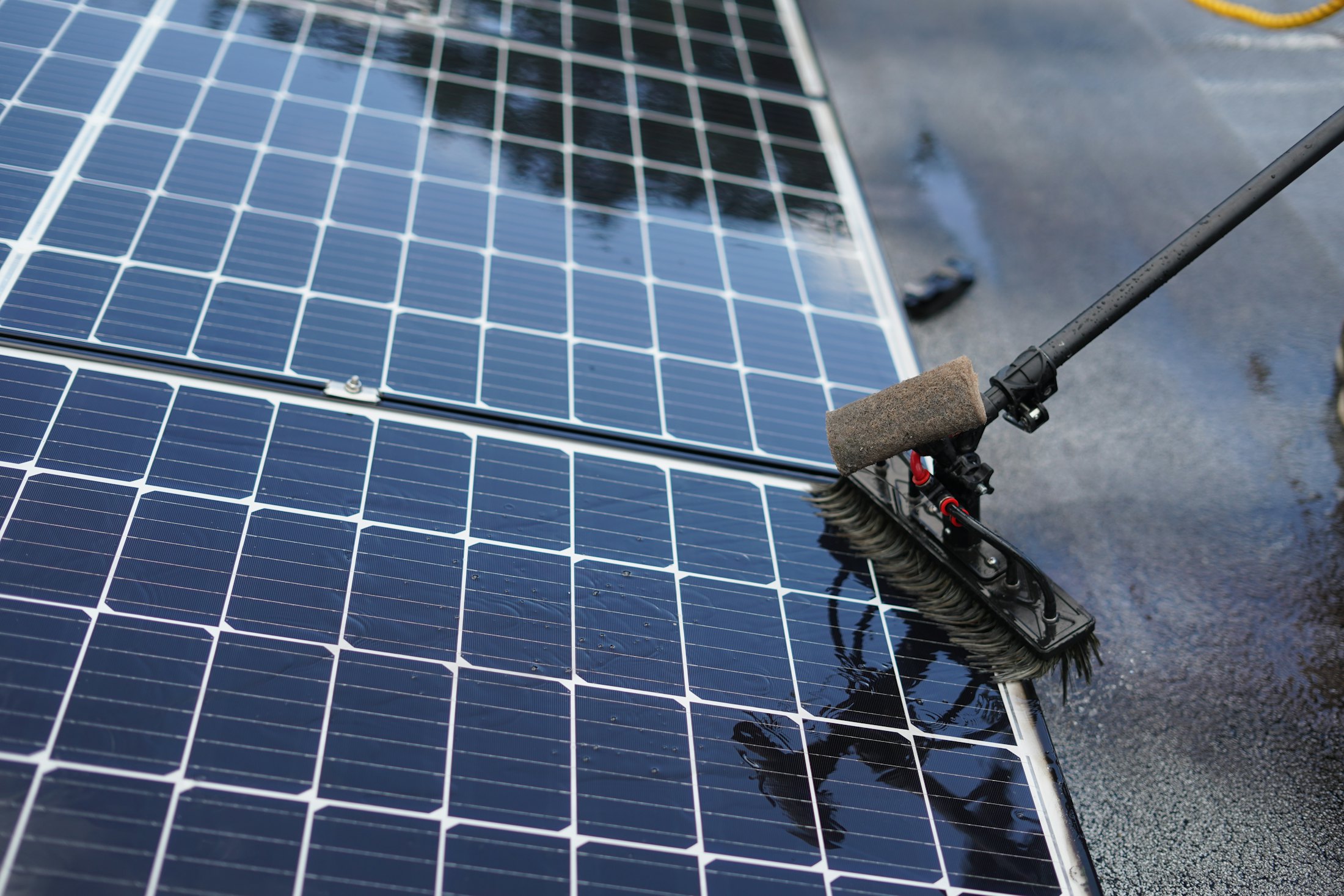 Spazzola con acqua che lava pannelli fotovoltaici